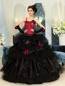 One Shoulder Red and Black Quinceanera Dress with Layered Ruffles and Flower